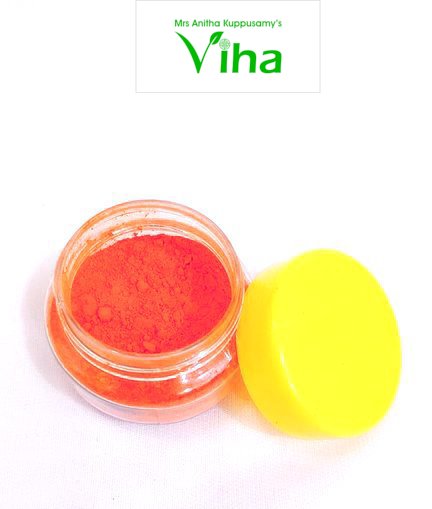 Sendhuram, small clear plastic jar filled with vibrant orange powder, with a round solid yellow cap resting beside it