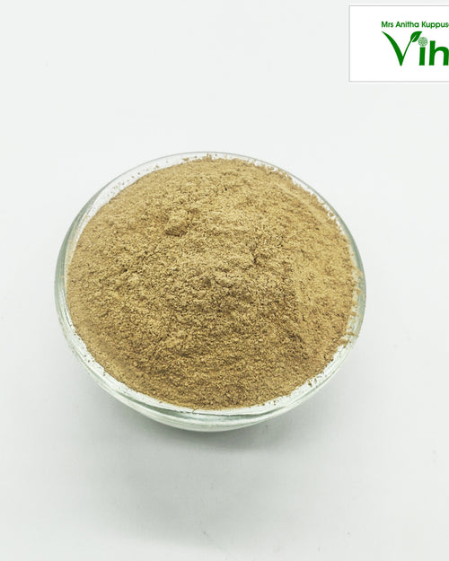 Adhimadhuram Powder / Liquorice Powder, a transparent glass bowl filled with a fine, light-brown powder set against a plain white background