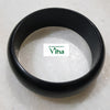 Karungali Wood Bangle, one thick, smooth, matte black circular bangle resting flat on a white surface