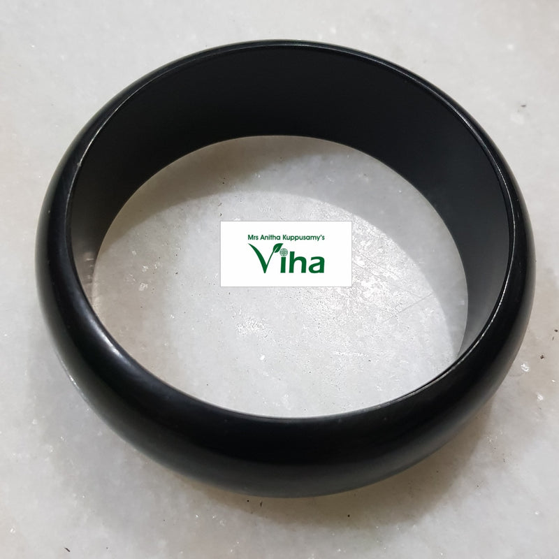 Karungali Wood Bangle, one thick, smooth, matte black circular bangle resting flat on a white surface