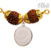Divya Gomathi Chakra Pendant, a brown and gold-toned pendant featuring two textured beads and one white circular disc pendant with a spiral pattern