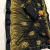 Designer Nylon Mono Net Saree With Blouse (inclusive of all taxes), black fabric featuring shiny gold-toned patterns and a solid black border