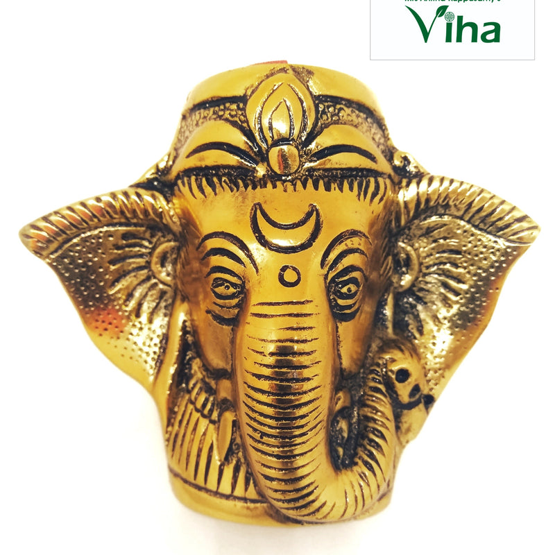 Ganesha Pen Stand Gold, a gold-toned metallic elephant head figurine with a fluted trunk, ornate headdress, and large flared ears against a white background