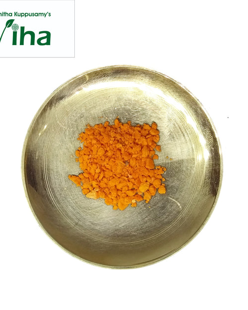 Korosanai (Gorochan), a shiny gold-toned shallow bowl holding a pile of orange granules