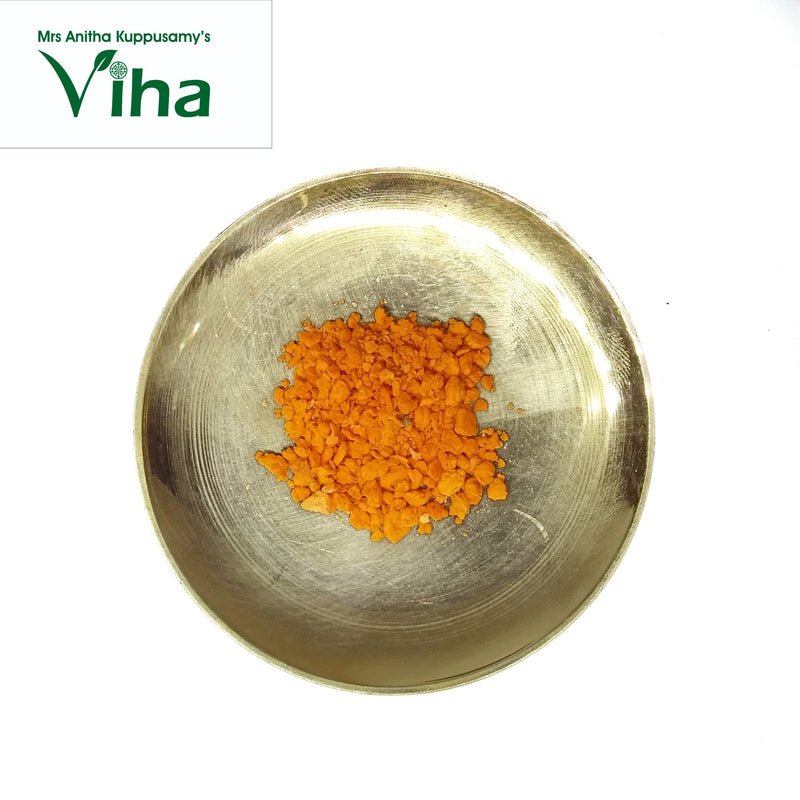 Korosanai (Gorochan), a shiny gold-toned shallow bowl holding a pile of orange granules