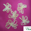 Five loose pale fibrous lotus stem wick pieces arranged on a magenta cloth