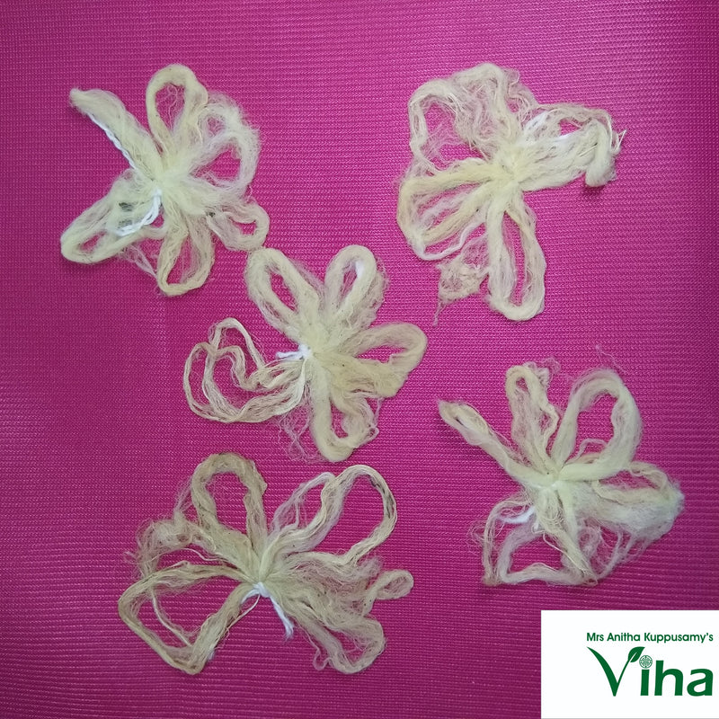Five loose pale fibrous lotus stem wick pieces arranged on a magenta cloth