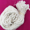 Akhand Jyoti Wick - s Length, a coiled bundle of white textured thread with loose ends on a pink background