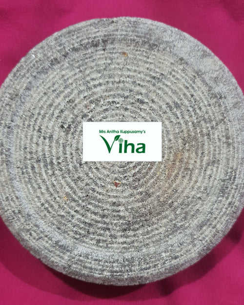 Turmeric Rubbing Stone, a grey textured circular flat stone object featuring multiple concentric grooved circular lines across its surface