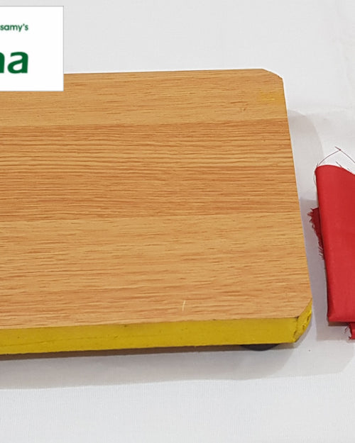 Manai With Red Cloth, a rectangular wooden-patterned board with yellow edges and a folded red fabric piece beside it