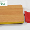 Manai With Red Cloth, a rectangular wooden-patterned board with yellow edges and a folded red fabric piece beside it
