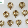 Set of premium brass Mahalakshmi pooja lamps, eleven small footed agal lamps laid out in rows