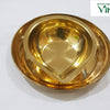 Vilakku Plate / Lamp Plate, a gold-toned metal bowl with a pointed lip rests inside a matching round tray with a fluted rim