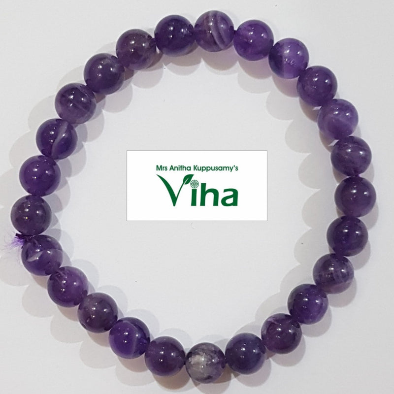 Amethyst Bracelet, bracelet of purple beads with one paler banded bead among them
