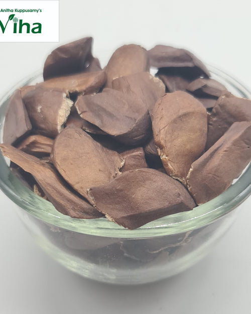 Thaen Kai, a transparent glass bowl filled with numerous flat, brown, irregular shaped pieces with matte finish showing light edges