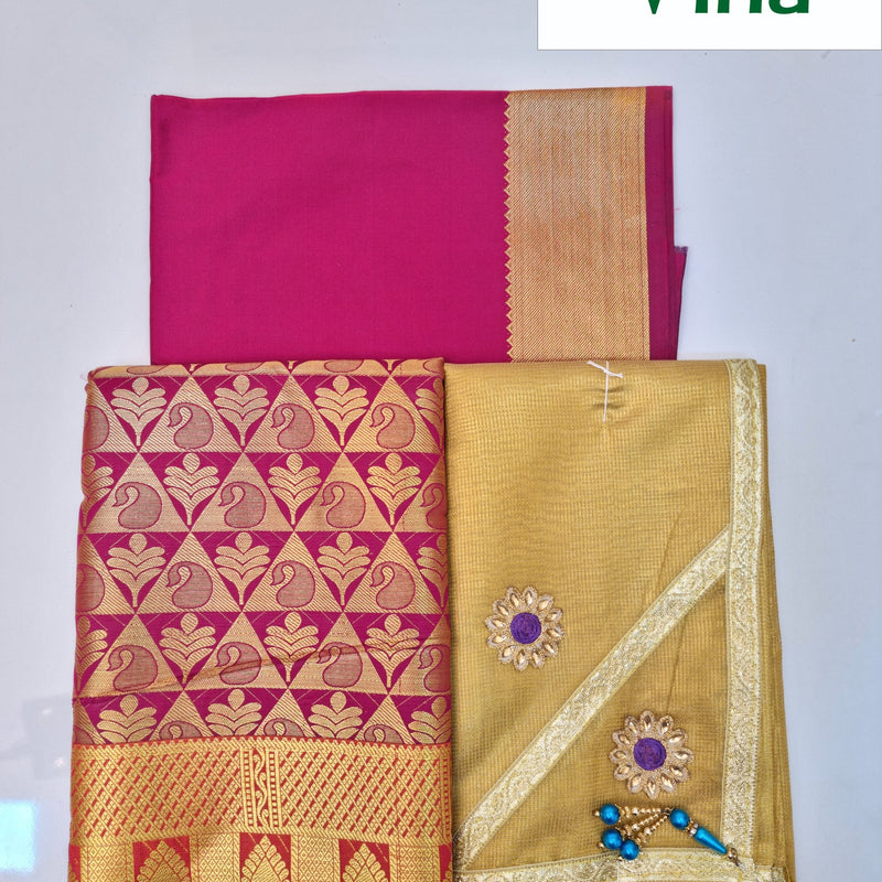 Apoorva Silk Half Saree Set, a magenta and a gold-toned fabric piece, one patterned with repeating gold-toned motifs and one adorned with two floral appliqués