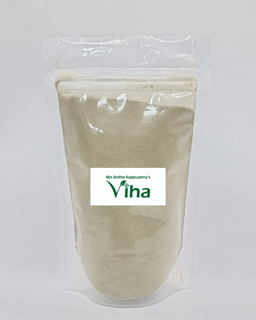 Amman Pacharisi Powder, a clear plastic pouch containing light-grey powder with one rectangular white label in the centre