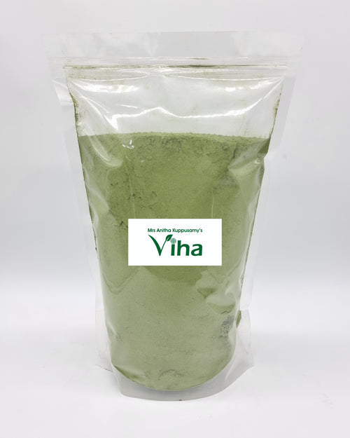 Indigo Powder, a transparent plastic stand-up pouch filled with fine green powder, featuring a rectangular white label with green text on the front