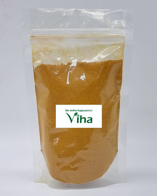Poosu Manjal Powder, a clear plastic zip-top pouch containing yellow-brown powder features a central white rectangular label with green text