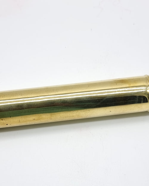 Agarbathi Storage Brass Container, a glossy gold-toned container holding many thin brown sticks poking out of one end