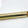 Agarbathi Storage Brass Container, a glossy gold-toned container holding many thin brown sticks poking out of one end