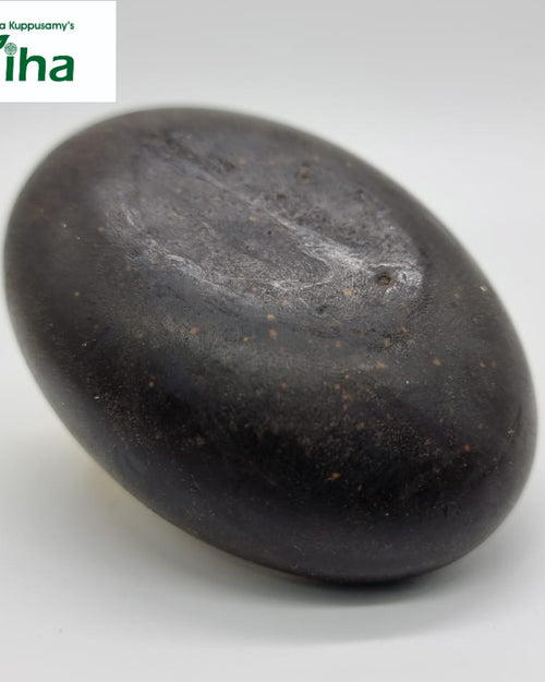 Shampoo Bar For Dry Hair, a dark brown oval object with a smooth, slightly glossy surface and tiny scattered speckles