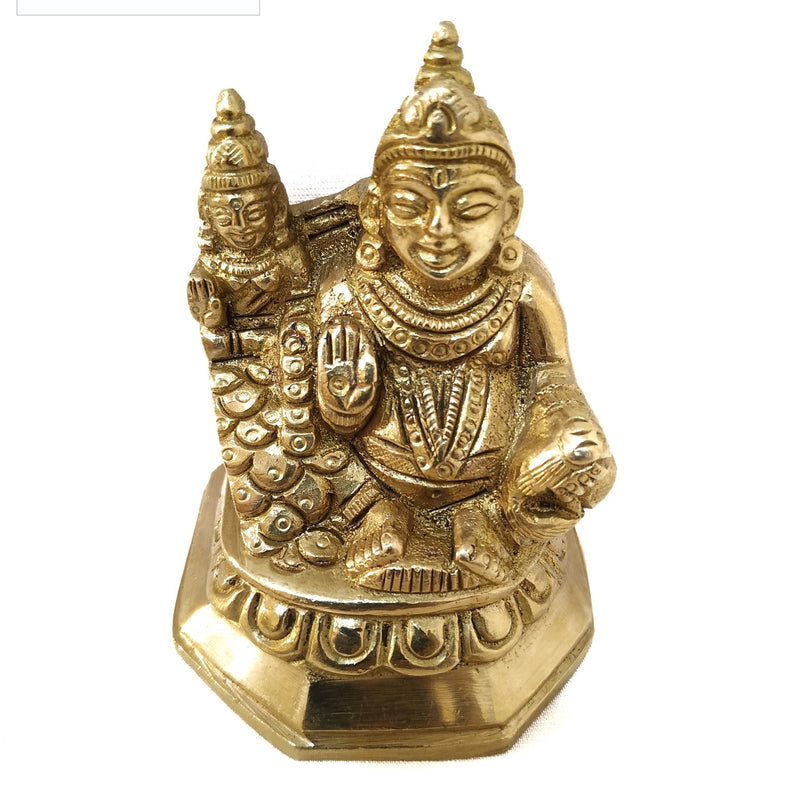 Kubera in brass, seated figure on an octagonal base with a small mound beside it