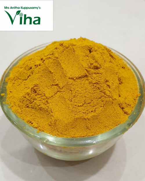 Kasturi Manjal / Wild Turmeric, a clear glass bowl filled with fine, textured yellow powder