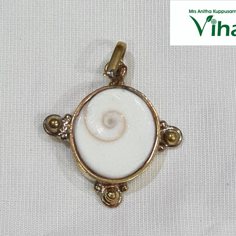 Gomathi Chakra Brass Pendant, a brass frame holding a Gomathi Chakra (spiral shell)