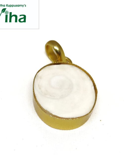 Gomathi Chakra Brass Pendant, a gold-toned pendant featuring a round, white flat inset with a spiral pattern and topped by a loop bail