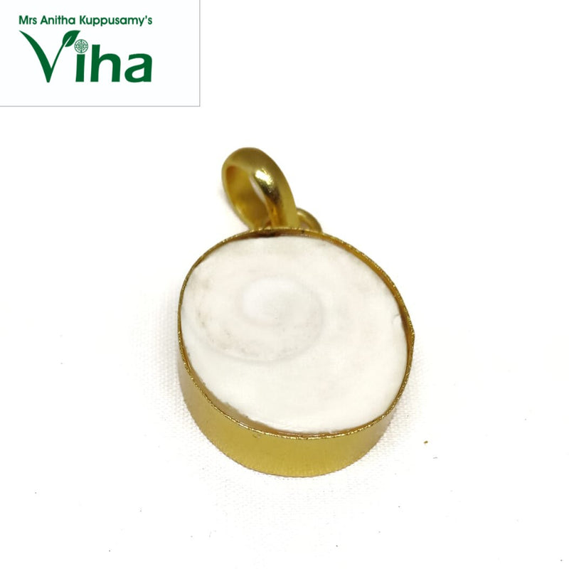 Gomathi Chakra Brass Pendant, a gold-toned pendant featuring a round, white flat inset with a spiral pattern and topped by a loop bail