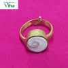 Gomathi Chakra Brass Ring - Women, a gold-toned metal ring featuring a round white stone with a spiral pattern set in the bezel