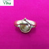 Gomathi Chakra Brass Ring - Men, an adjustable metallic ring featuring an oval-shaped, mottled-pattern stone against a solid pink background