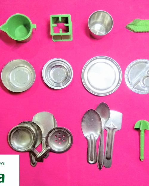 Steel Soppu Saman, eighteen metal-colored and five colorful miniature kitchenware pieces arranged neatly against a pink background
