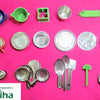 Steel Soppu Saman, eighteen metal-colored and five colorful miniature kitchenware pieces arranged neatly against a pink background