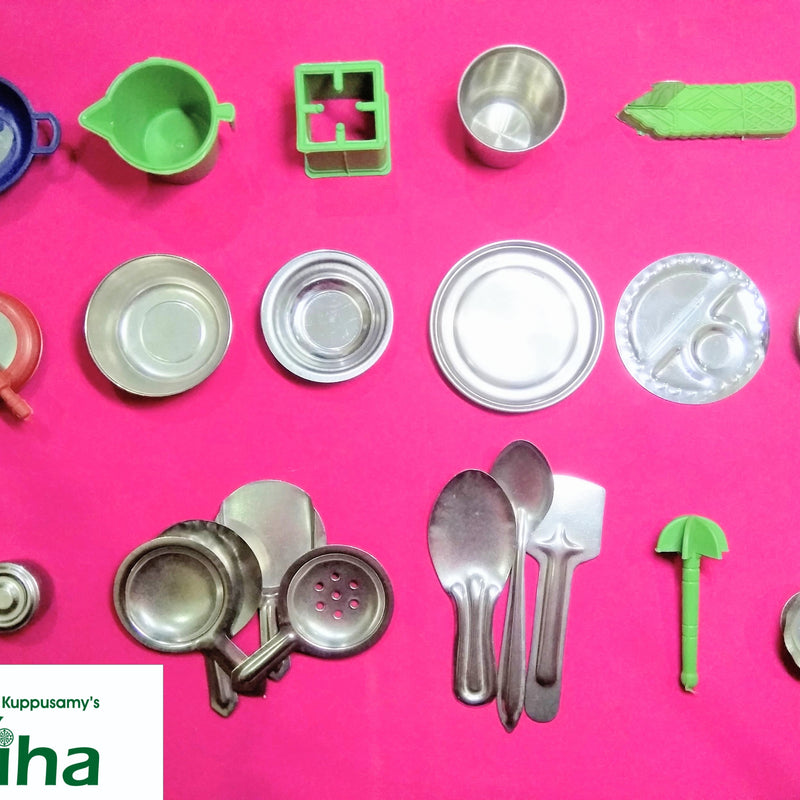 Steel Soppu Saman, eighteen metal-colored and five colorful miniature kitchenware pieces arranged neatly against a pink background