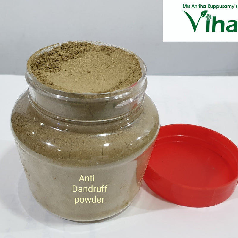 Anti Dandruff Powder, a transparent plastic jar containing brownish-green powder, featuring a label and accompanied by a detached red lid