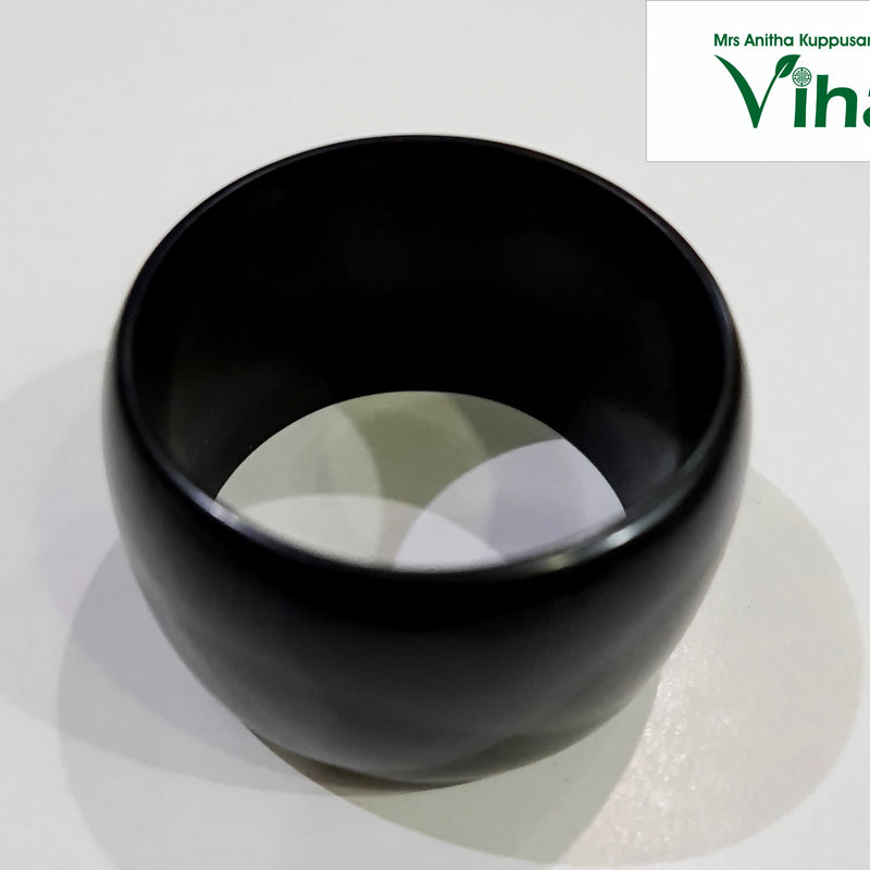 Karungali Wood Bangle, one thick black ring with a smooth finish resting on a white surface