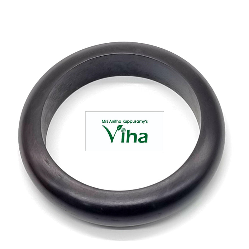 Karungali Bangle, a thick, smooth, dark brown circular bangle with a polished surface finish