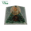 Green Aventurine Pyramid, a green pyramidal object with embedded stones, gold-toned geometric symbols, and one copper-coloured spiral coil