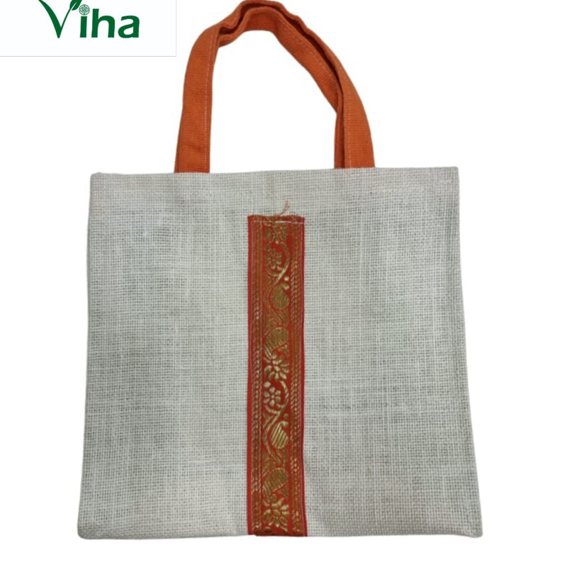 Jute Bag with Zip, a square off-white woven bag with two orange handles and a vertical orange and gold-toned patterned stripe centered on the front face