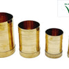 Four brass measuring cups in graduating sizes, largest to smallest