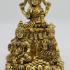 Kuberar Statue - Brass, a gold-toned metallic statue of three seated figures on a pile of coins and pots