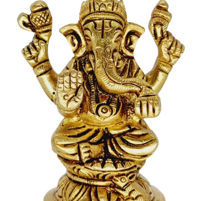 Ganesha in brass, four-armed elephant-headed figure seated on a tiered round pedestal with a curled trunk
