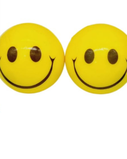 Smiley ball with Racing Car, two glossy yellow spheres with black smiling faces alongside two small toy cars, one blue and one green