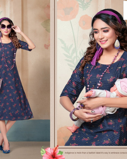 Feeding Kurti Full Stitched, a woman in a blue patterned dress with half sleeves, purple headband, and long pink beaded necklace holds a doll