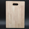 Viha's Wooden Chopping Board - Small, a rectangular wooden board with rounded corners features one horizontal oval cutout near the top edge