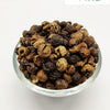 Sundaikkai Vathal (Turkey Berry Fryums), a glass bowl filled with numerous wrinkled, brown and tan round seeds against white background