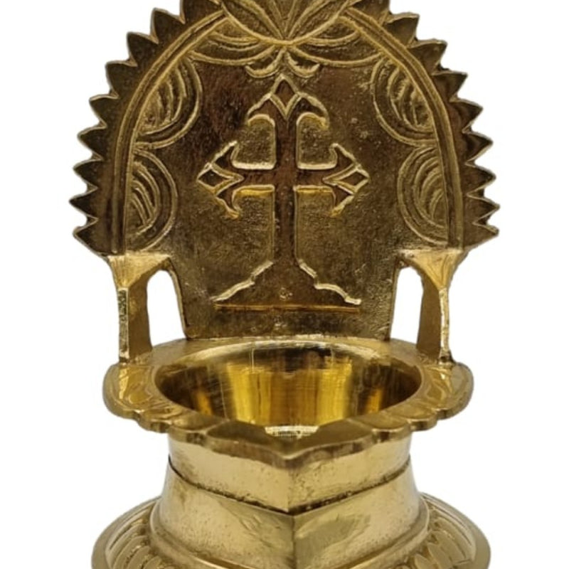 Brass cross lamp, Christian cross set in a rayed arch backplate above an oil bowl and stepped base