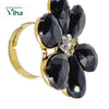 Fancy Designer Stone Ring, a gold-toned ring featuring a flower motif set with six faceted black teardrop stones and seven clear round stones at its center